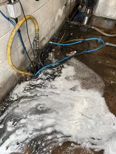 Condition of the wash bay area before installation of the new Nilfisk SH Truck static system. The previous mobile setup had left the area wet and dirty from regular daily fleet cleaning operations, highlighting the need for a cleaner and more permanent in
